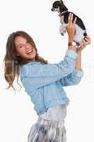 Happy woman lifting her chihuahua