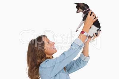 Pretty woman lifting her chihuahua up