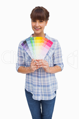 Happy woman with fringe showing colour charts
