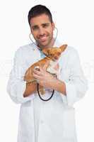 Happy vet checking dog with stethoscope