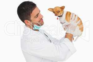 Happy vet holding chihuahua and smiling