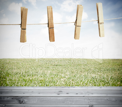 Clothespin on a laundry line outside above wooden boards