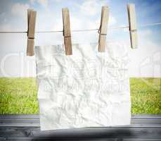 White crumpled paper hung on a laundry line