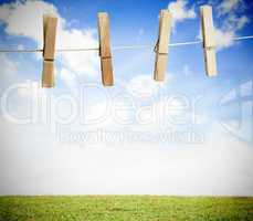 Clothespin on a laundry line outside with bright blue sky