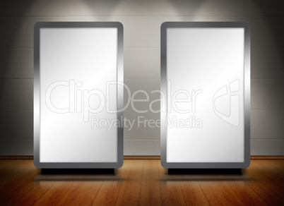 Two blank screens standing on wooden floor