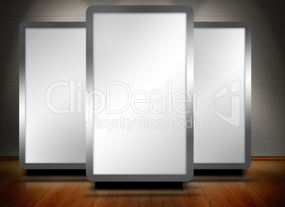 Three blank screens standing on wooden floor