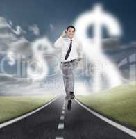 Businessman running on a road with dollars floating