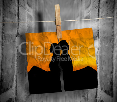 Torn photo of couple hung with a peg on a line