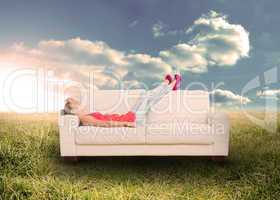 Woman relaxing on couch in field