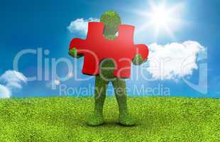 Green character holding a red jigsaw piece