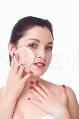 Attractive woman rubbing her skin with close up of her wrinkles