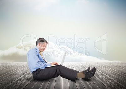 Mature businessman over wooden boards leading out to the horizon