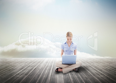 Cute blonde woman using laptop over wooden boards