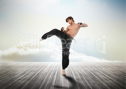Martial arts fighter over wooden boards
