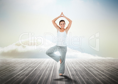 Woman practicing yoga over wooden boards