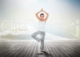 Woman practicing yoga over wooden boards