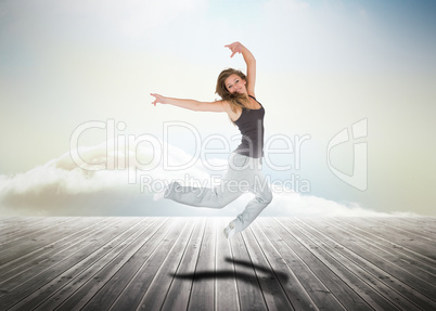 Woman jumping over wooden boards