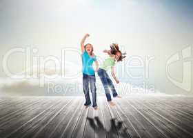 Sisters having fun jumping over wooden boards