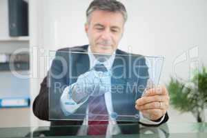 Businessman using futuristic touchscreen to view graph