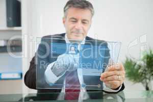 Businessman using futuristic touchscreen to view social media pr