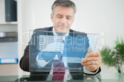 Businessman using futuristic touchscreen to view social network