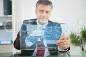 Businessman using futuristic touchscreen to view social network