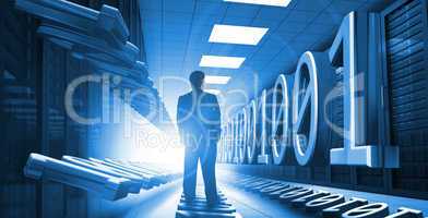 Businessman standing in data center with binary code