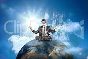 Businessman sitting on top of the world