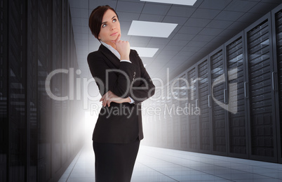 Businesswoman looking thoughtful in data center