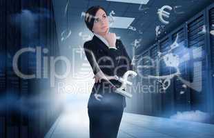 Businesswoman standing in data center with currency graphics