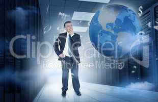 Businessman standing in data center with currency graphics and e