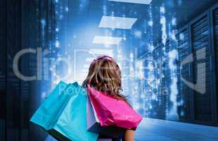 Girl with shopping bags looking at falling matrix