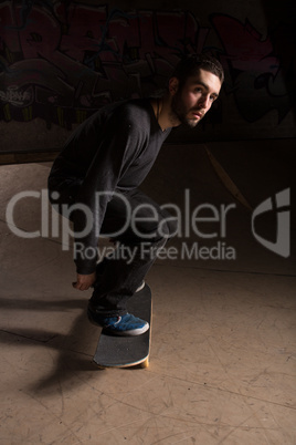 Skater bending his knees to prepare for a trick