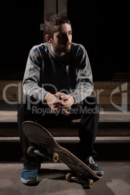 Skater sitting on steps in the skate park