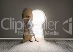 Businesswoman leaning against keyhole shaped doorway