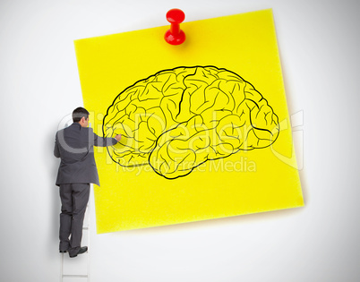 Businessman drawing a brain on a giant post it