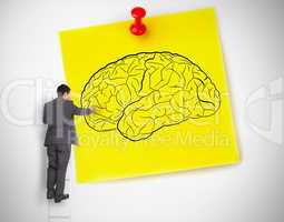 Businessman drawing a brain on a giant post it
