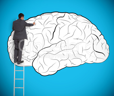 Businessman drawing a brain on a giant wall