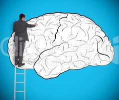 Businessman drawing a brain on a giant wall