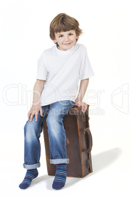 Young Happy Boy Smiling Sitting on Suitcase