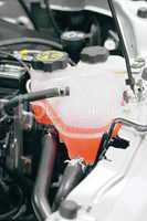 Coolant container in a car's