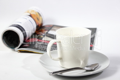 Coffee and magazine on a white