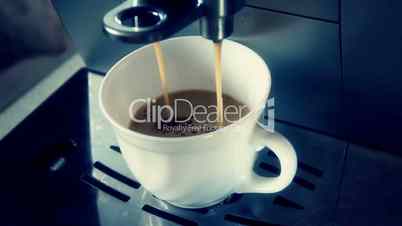 coffee machine pouring espresso in cup