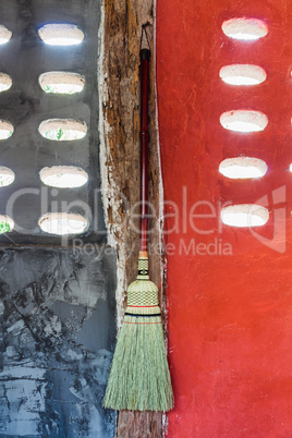 Broom hanging on the wall ready for cleaning work