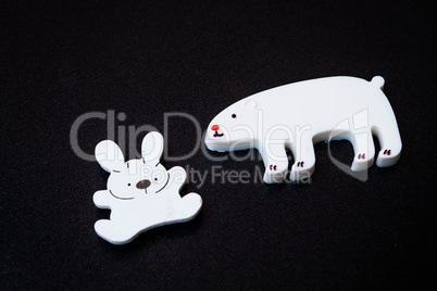 Close up white animal magnets on dark background