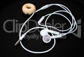 White ear buds and line store isolated on dark background