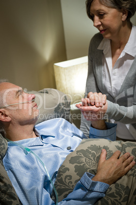 Old woman taking care of sick husband