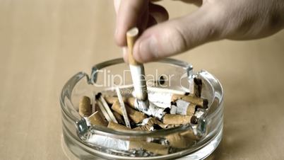 Man putting out cigarette in ashtray