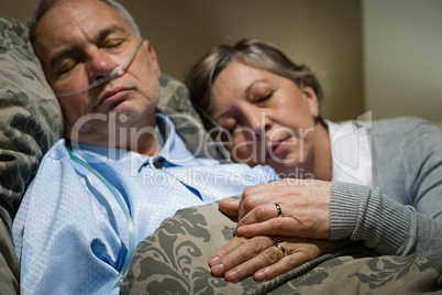 Old couple sleeping together man nasal cannula