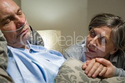Anxious old woman taking care of husband